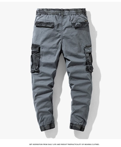 Detail view of cargo pants featuring camo patchwork on side pockets and elastic cuffs