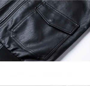 Detail of black faux leather jacket featuring flap pockets and fine pebble grain texture