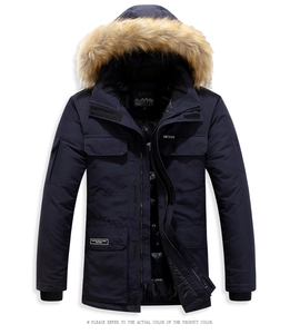 Detail view of mens navy winter parka featuring a thick faux fur collar and multi-pocket design