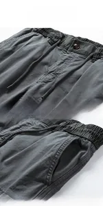 Detail of cargo pants showing elastic drawstring waist and side pocket texture