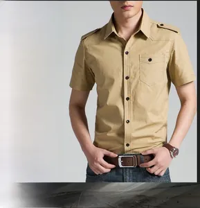 Detail view of khaki military style cotton shirt featuring shoulder straps and flap pocket