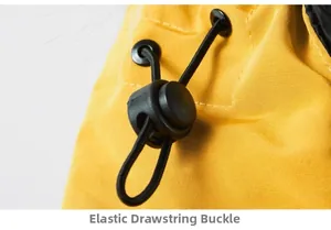 Macro detail of elastic drawstring buckle on yellow heavy-duty workwear cotton coat