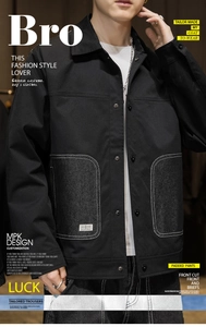 Detail view of men's black utility jacket with contrast white stitching and round pockets