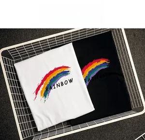 Close-up of folded cotton t-shirts in black and white with rainbow gradient print