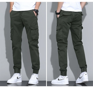 Detail view showing cargo pockets and elastic waistband on dark green joggers