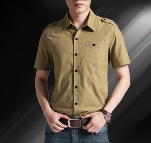 Detail of khaki military style cotton shirt with shoulder epaulettes and button pocket