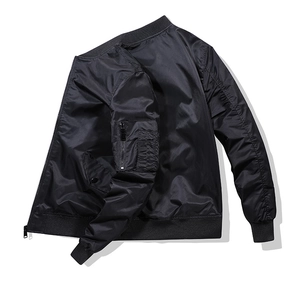 Detail of classic black bomber jacket sleeve with zipper pocket and ribbed cuff texture