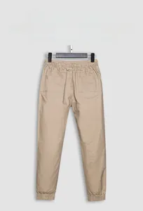 Detailed view of khaki drawstring waist joggers with ribbed cuffs and rear pocket design