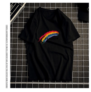 Close-up of black cotton T-shirt featuring colorful RAINBOW graffiti print and crew neck