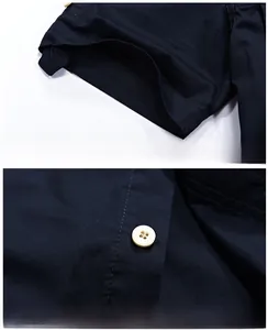 Detail view of navy cotton shirt showing professional cuff stitching and button placket