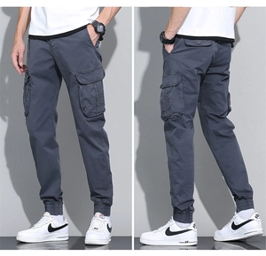 Detail view of cotton cargo pants showing rib cuffs and large utility pockets
