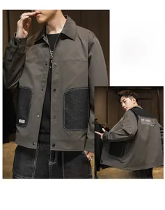Detail of men's casual workwear jacket featuring contrast color blocking and back print