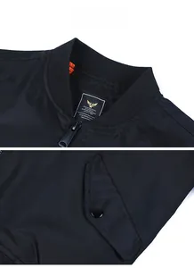 Detail of MA-1 bomber jacket featuring ribbed collar, snap pocket, and orange lining