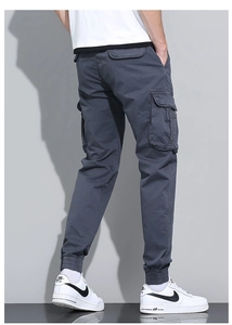 Detail view of cotton cargo pants for men featuring elastic cuffs and side patch pockets
