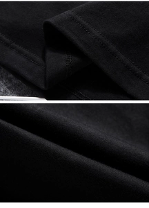 Detailed close-up showing double-needle stitching and soft knit cotton fabric on a black T-shirt