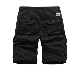 Rear view of black cargo shorts with flap pockets and woven label on white background