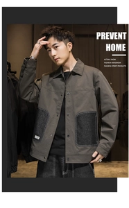 Detailed view of olive green canvas jacket with large grey utility pockets and buttons