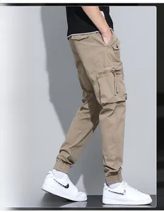 Detail view of khaki cargo pants with large side pockets and elastic ankle cuffs