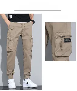 Detailed view of khaki cargo pants featuring elastic drawstring waist and multi-pocket design