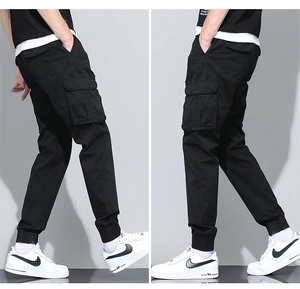 Detail view of black cargo joggers with side flap pockets and ribbed ankle cuffs