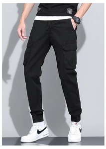 Detail of men's black cargo pants featuring elastic drawstring waist and side flap pockets