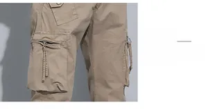 Detail view of khaki cargo pants featuring functional multi-pockets and metal zippers