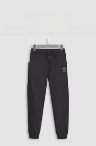 Detail view of black jogger pants featuring an elastic drawstring waist and MONTVOO brand label