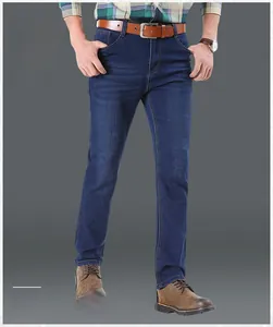 Detail of dark blue straight-leg denim pants featuring classic five-pocket styling and stitching