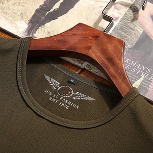 Men's army green crewneck t-shirt in breathable mesh fabric on a wooden hanger