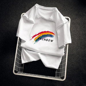 White cotton t-shirt featuring rainbow print and text inside a white metal basket