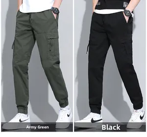 Detail view of cotton cargo joggers featuring side flap pockets in green and black colors