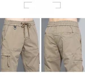 Detail of khaki cargo pants with elastic drawstring waist and signature metal ring