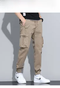 Detail view of khaki multi-pocket cargo pants with tactical zippers and elastic waistband