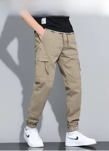 Detail of khaki cargo joggers showing zipper pocket and durable cotton canvas texture