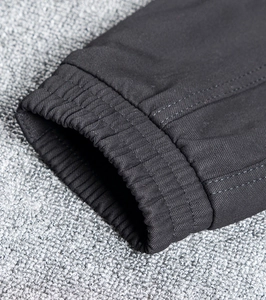 Detail of elastic ribbed cuffs with reinforced stitching on dark grey cargo joggers