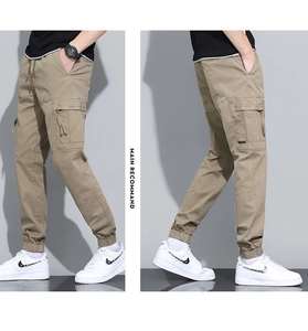 Detail view of khaki cotton cargo pants featuring side pockets and elastic ankle cuffs