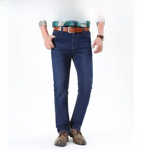 Detail of men's dark blue straight-leg jeans with classic wash and brown leather belt