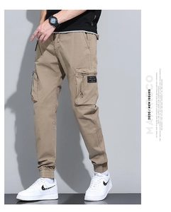 Close-up of khaki cargo pants featuring large utility pockets and elastic ribbed cuffs