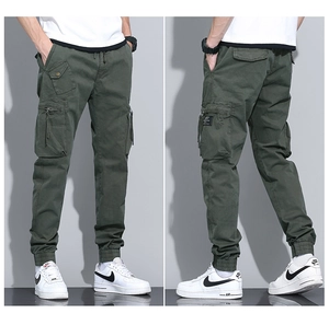 Detail view showing multi-pocket design and elastic cuffs on green cargo joggers for men