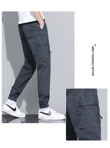 Detailed close-up of charcoal grey cargo pants featuring functional flap pockets
