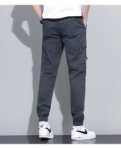 Detail view of cotton cargo pants showing tapered cuffs and functional side pockets