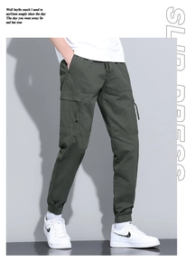 Detailed view of olive green cargo pants featuring elastic cuffs and side flap pockets