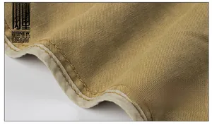 Close-up of khaki twill fabric showing detailed inner hem binding and double stitching
