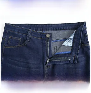 Detail view of dark blue business casual jeans showing metal zipper and stitching