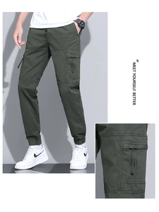 Detail view of cargo pants featuring drawstring waist and large flap utility pocket