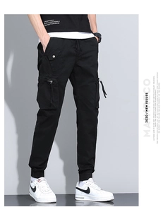 Detailed macro view of black cargo joggers featuring zip pockets and ribbed cuffs