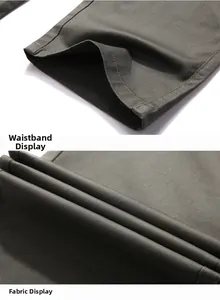 Detailed macro view of dark green trousers showing waist construction and twill fabric texture