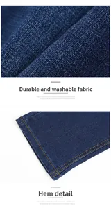 Detailed macro view of dark blue denim fabric texture and double-stitched hem on jeans