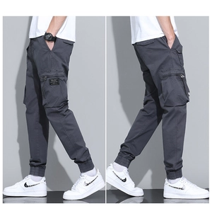 Detail view of charcoal gray cargo joggers with multi-pockets and zipper accents