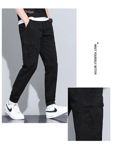 Detail view of cotton cargo joggers with large side pockets and elastic cuffs